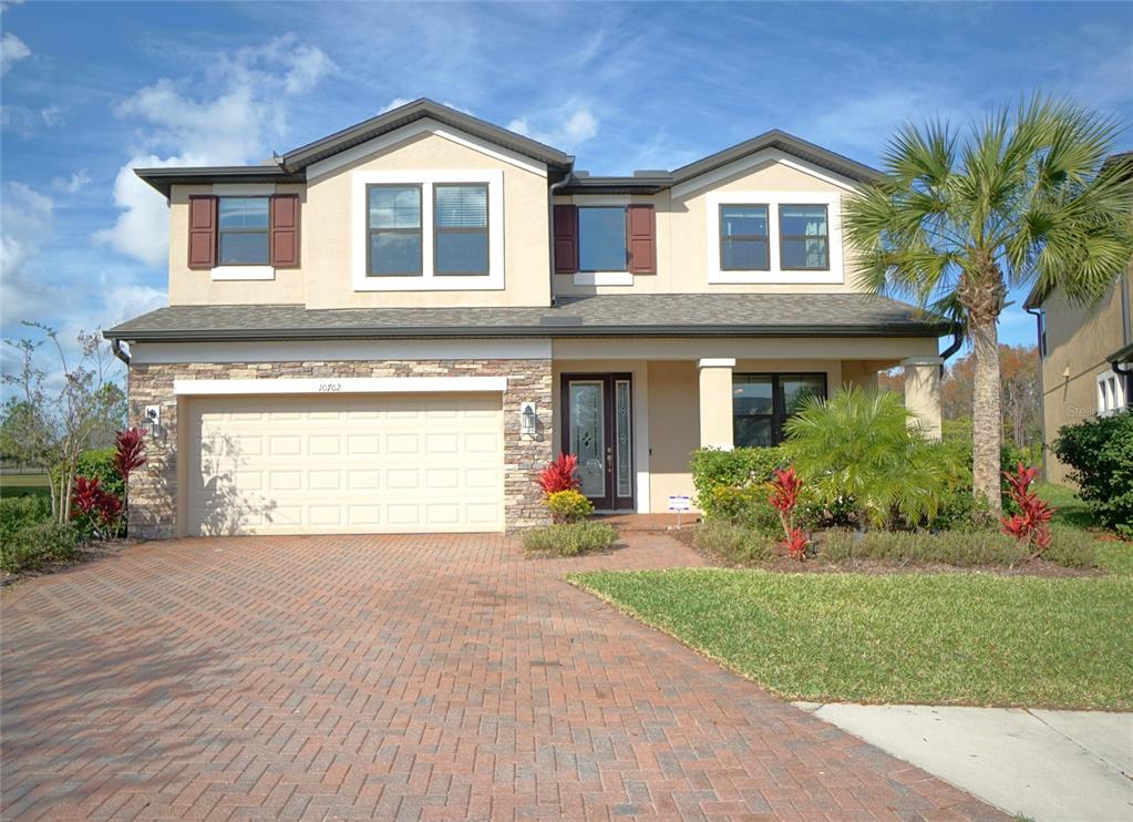 a front view of a house with a yard and garage