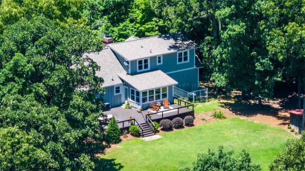 an aerial view of a house with swimming pool garden view and a chairs