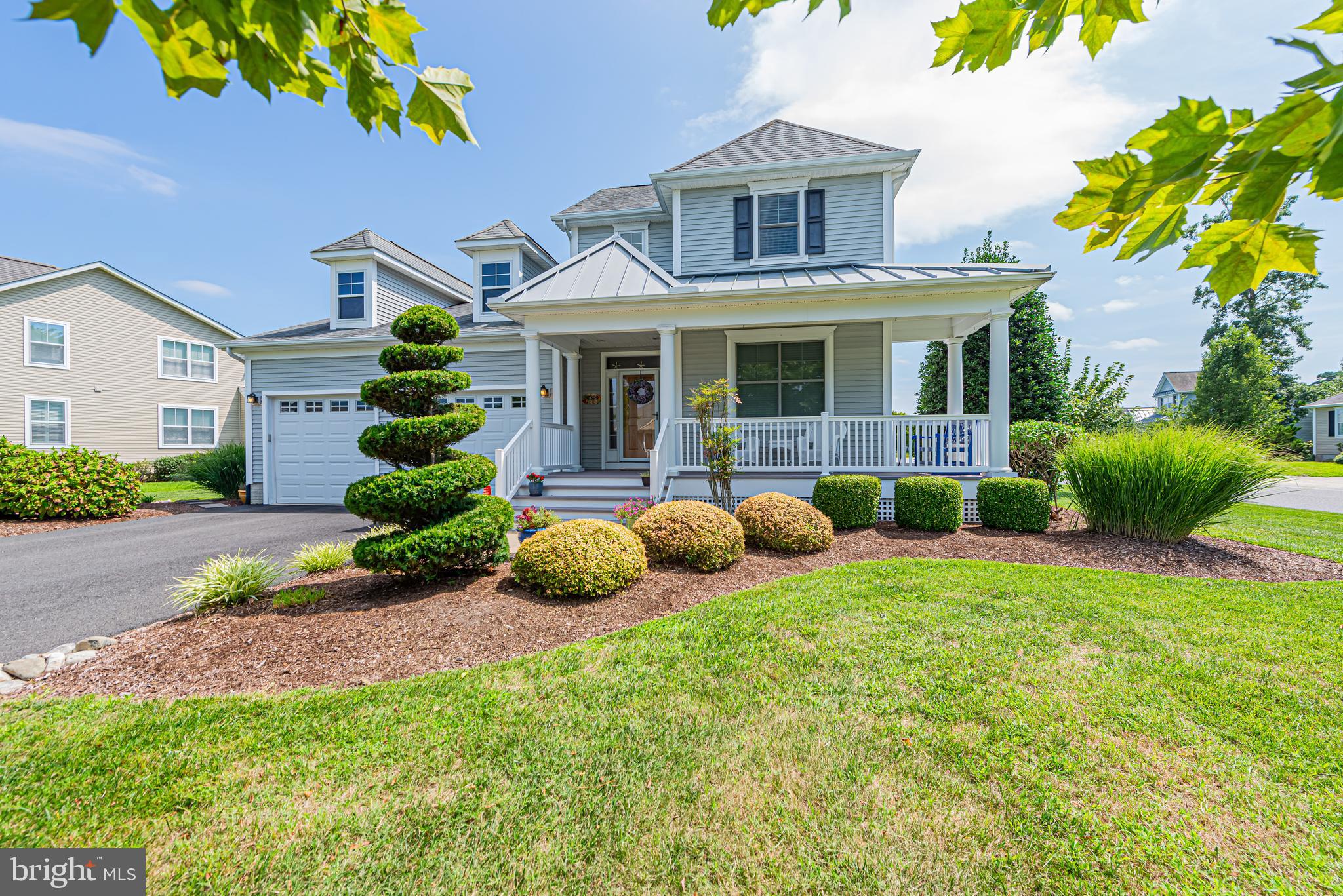 a front view of house with yard and outdoor seating