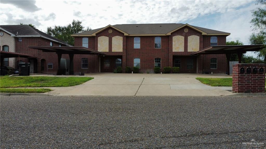 a front view of a house with a yard and a garage