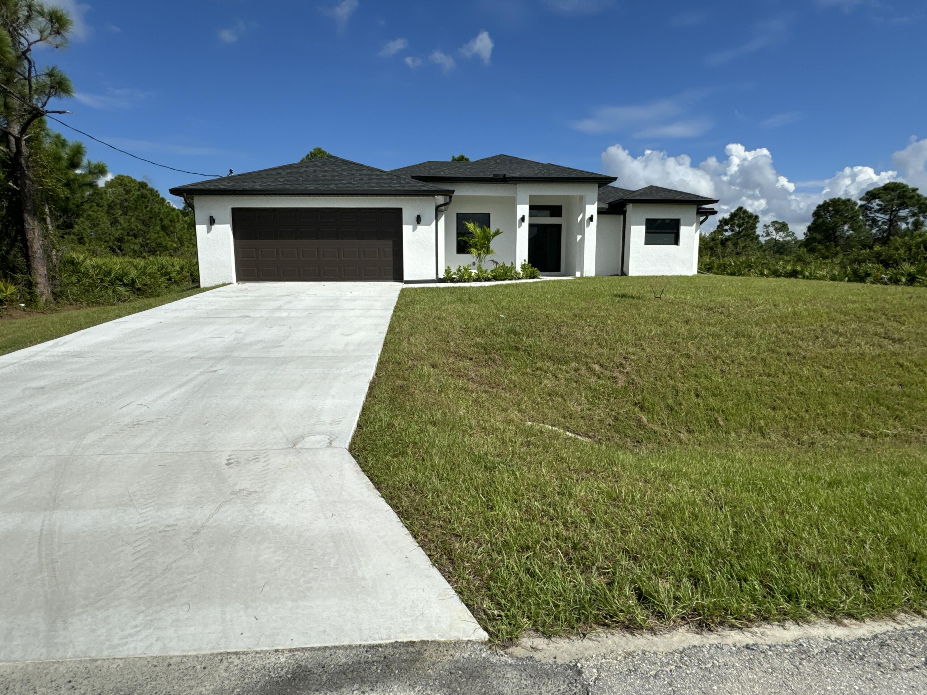 a view of white house with a yard