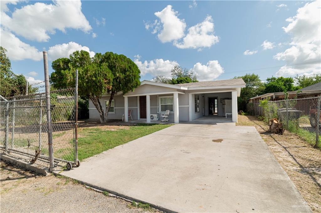 a view of a house with a backyard