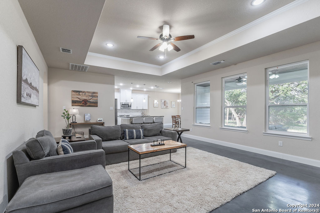 a living room with furniture and a large window