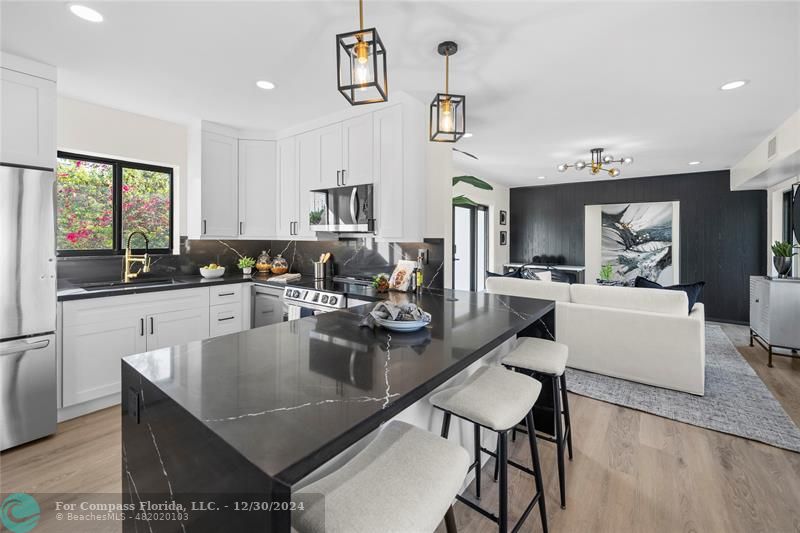 a kitchen with a dining table chairs and window