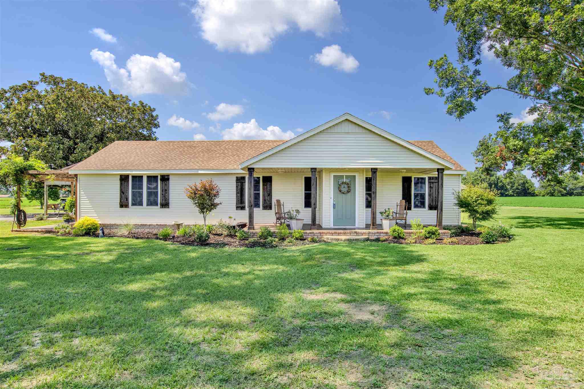 a front view of a house with a garden