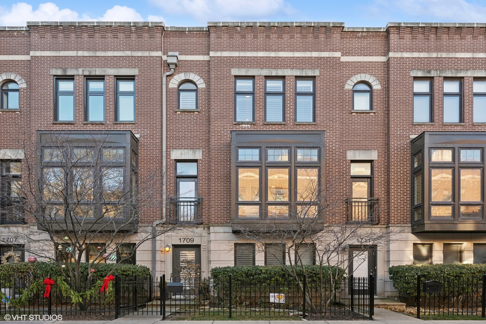 a front view of a residential apartment building with a yard