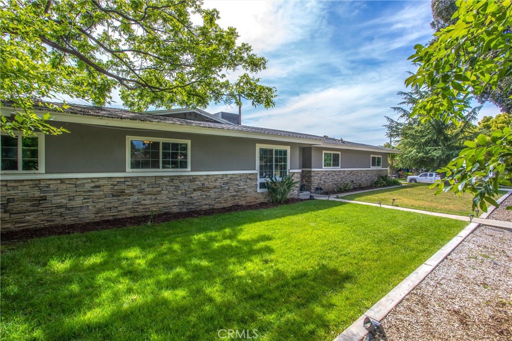 a view of house with backyard