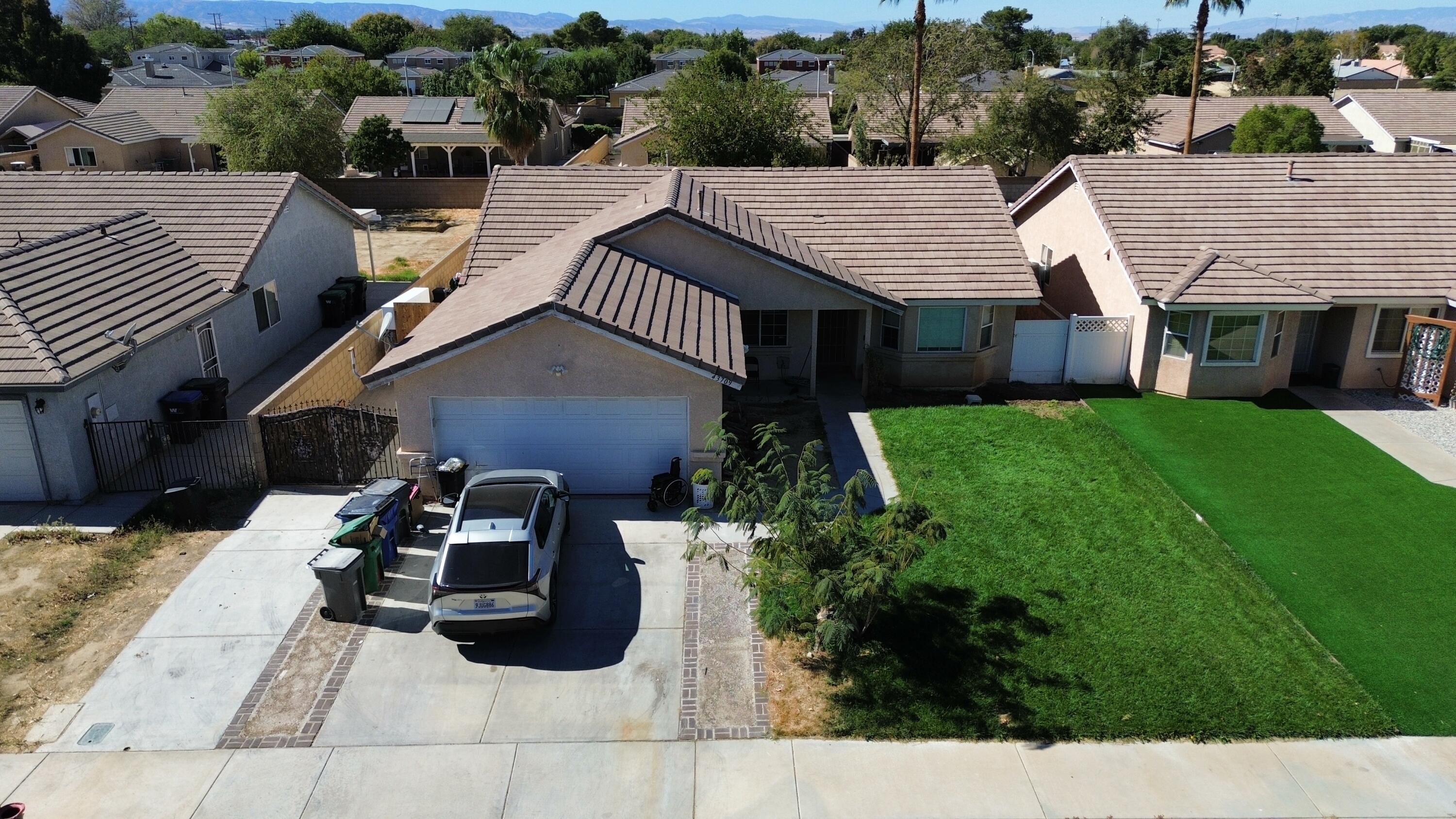 a view of a house with backyard and sitting area