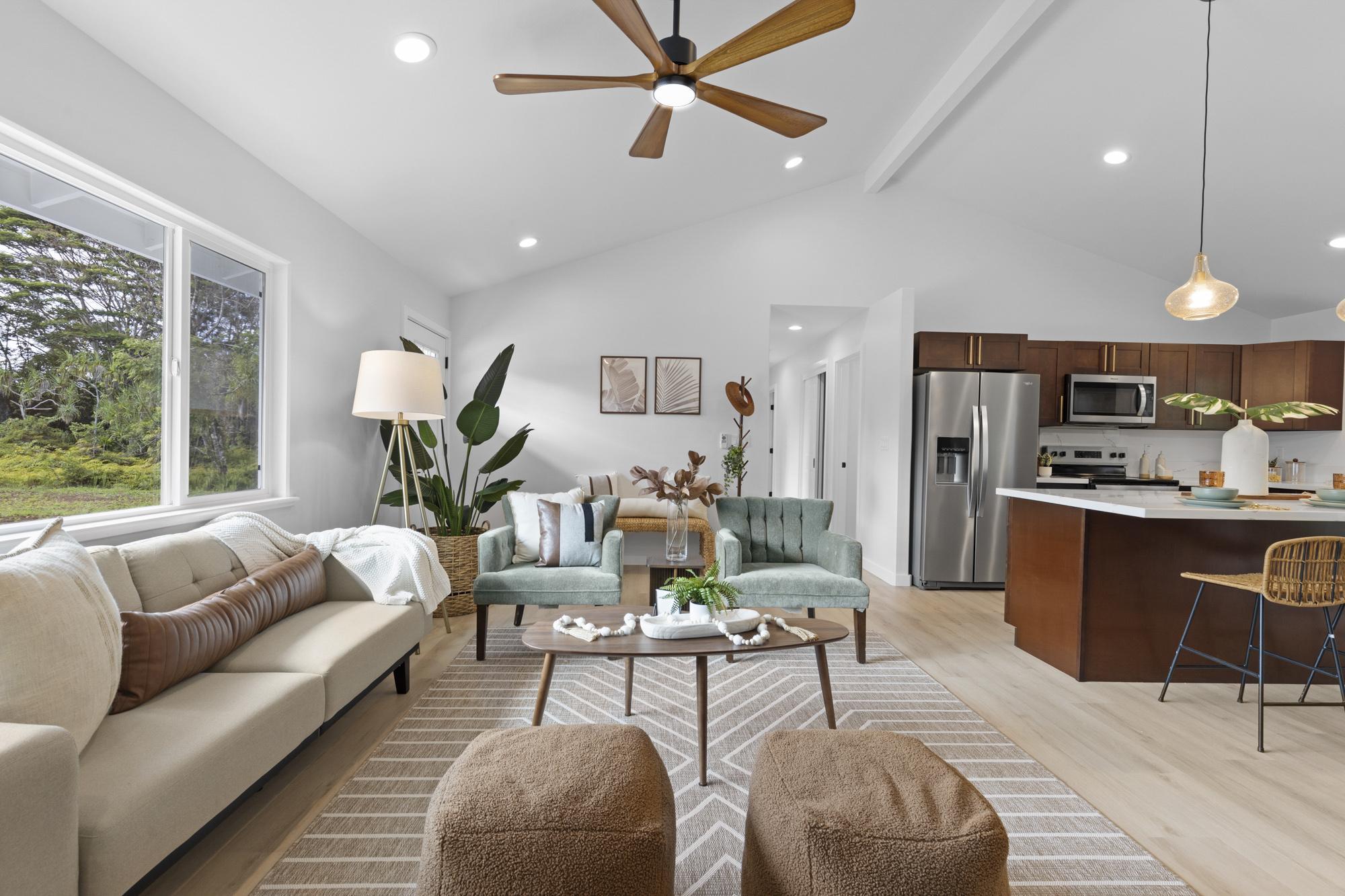 a living room with furniture kitchen and a table