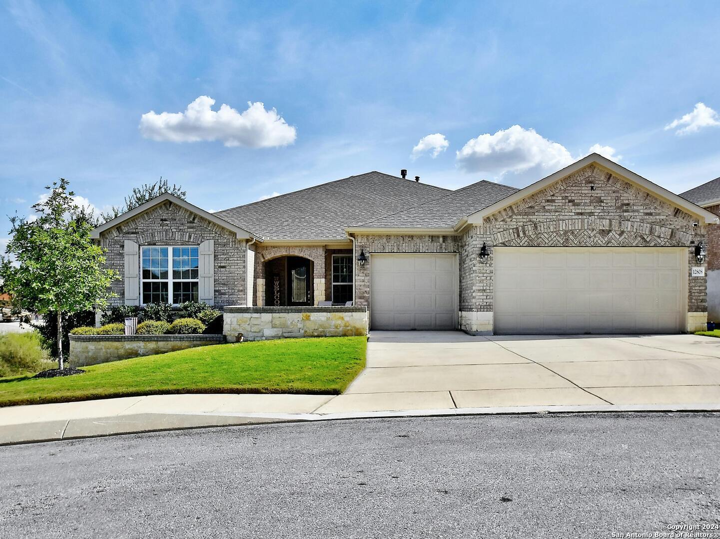 a front view of a house with a yard and garage