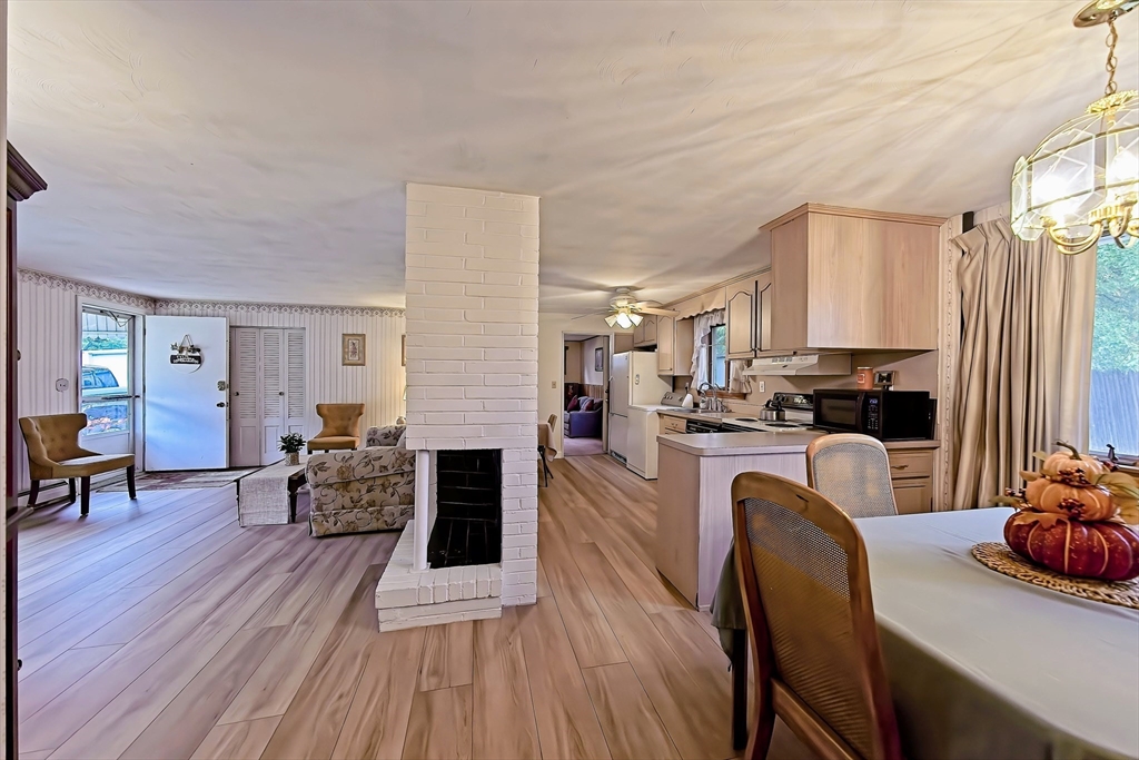 a dining room with furniture and wooden floor