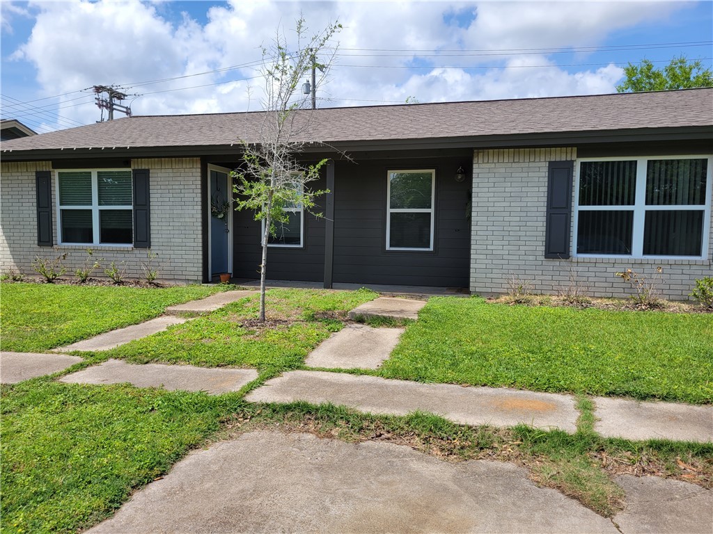 Single story home featuring a front lawn