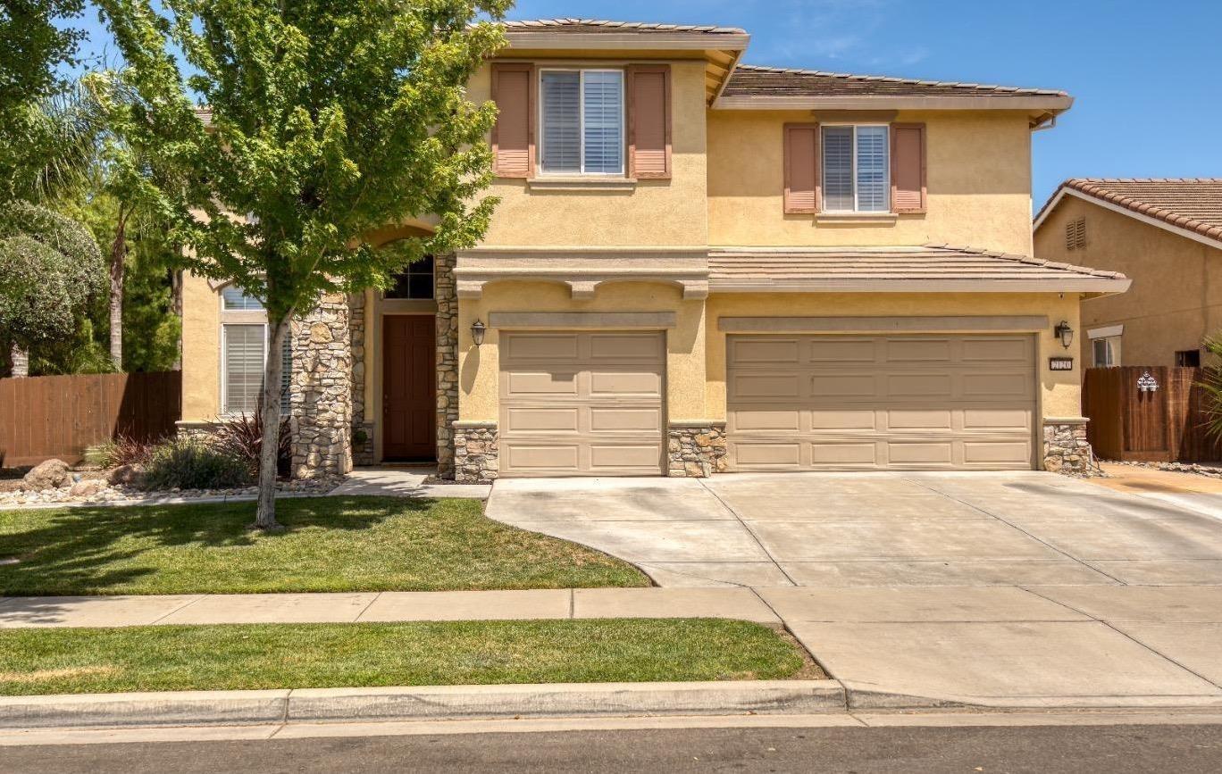 a front view of a house with garage