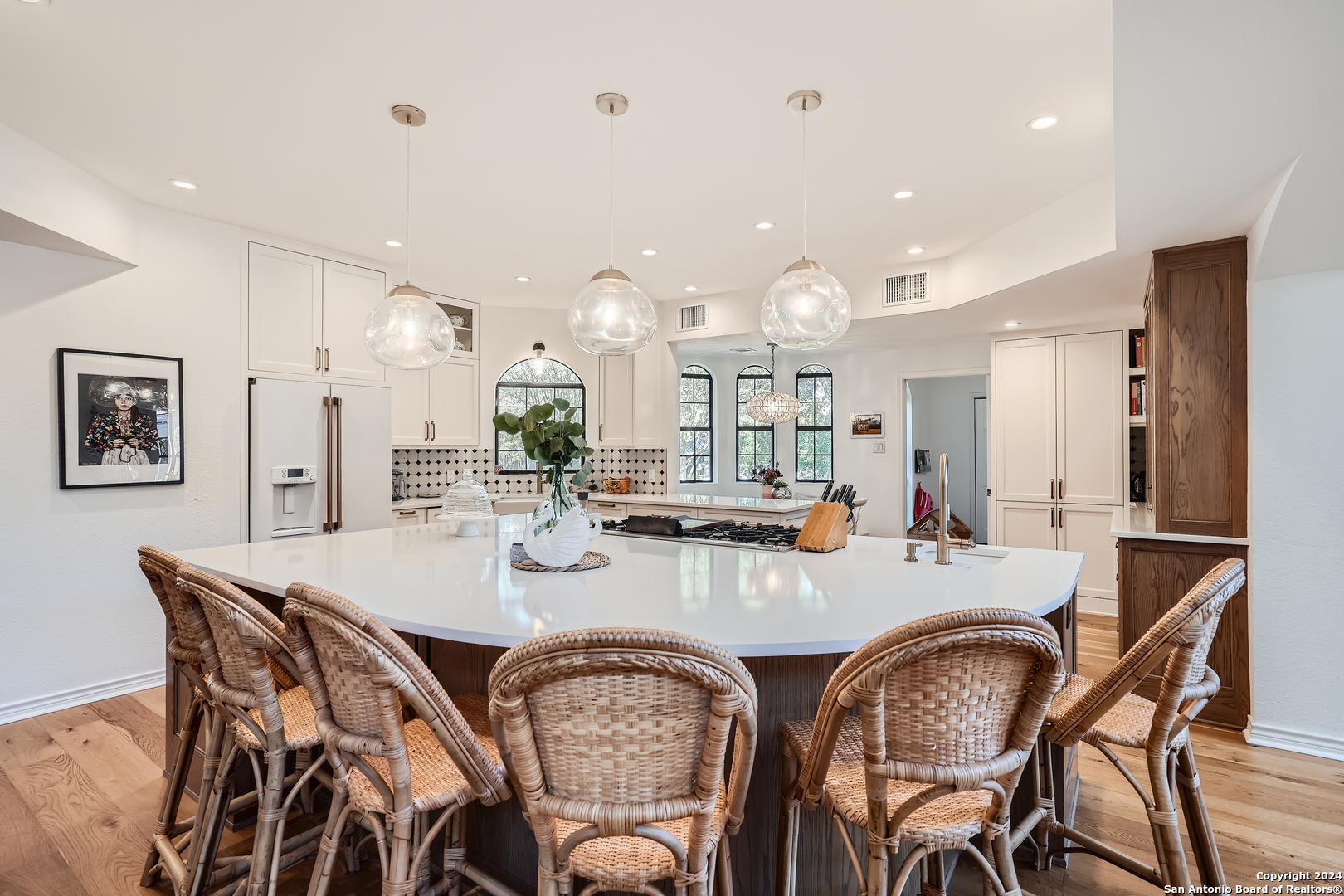 a dining room with stainless steel appliances kitchen island a table and chairs