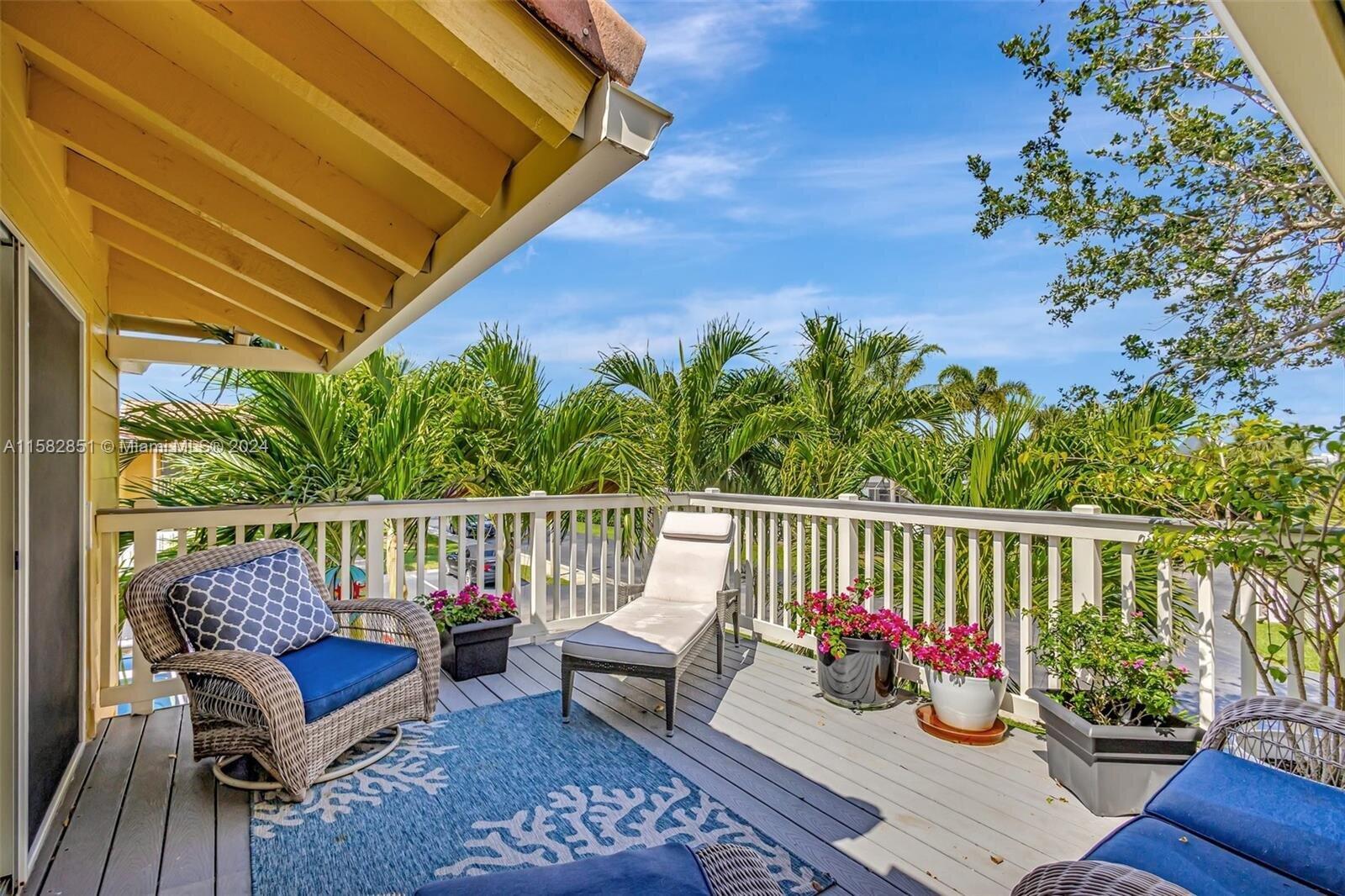 a view of a balcony with furniture