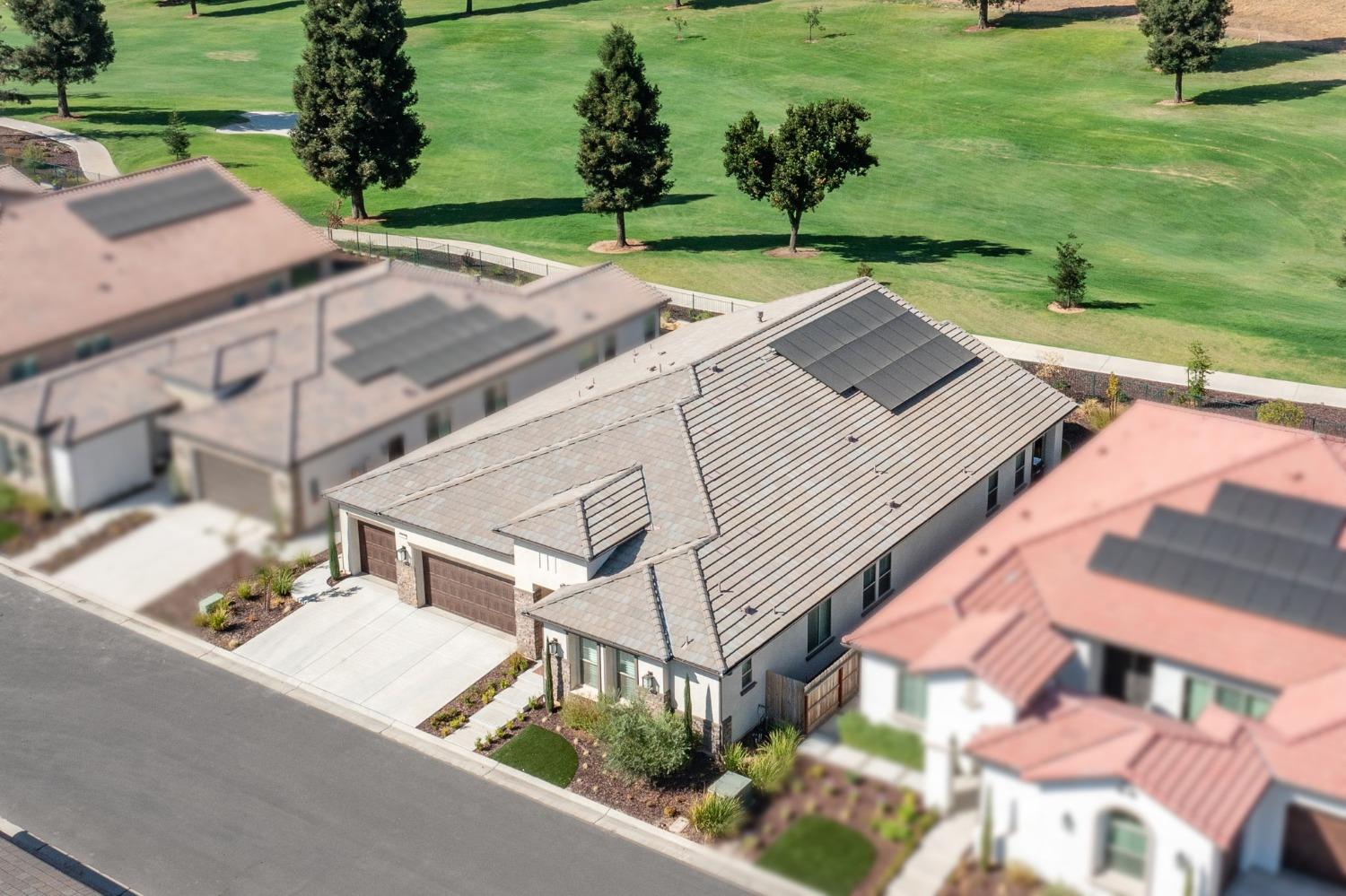 an aerial view of a house with garden space and street view