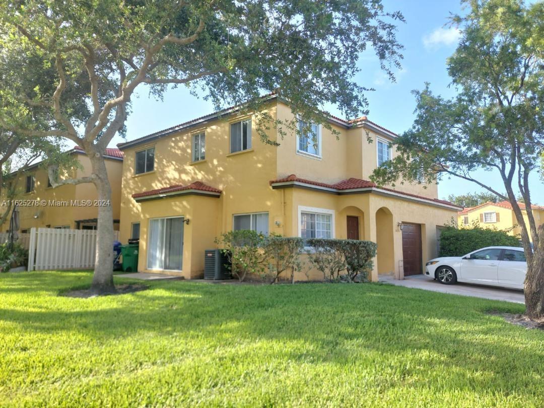 a front view of house with yard and green space