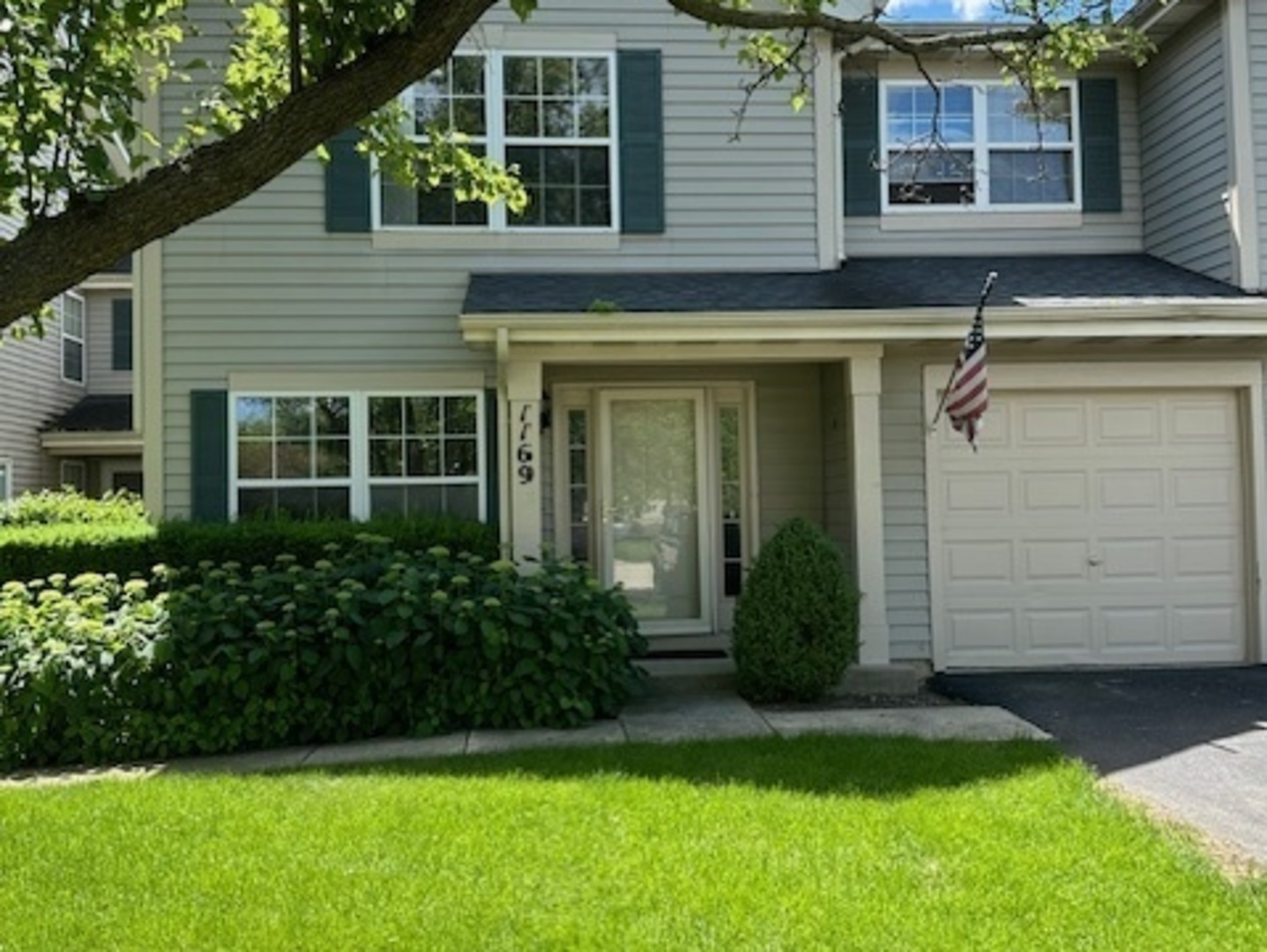 a view of a house with a yard and plants