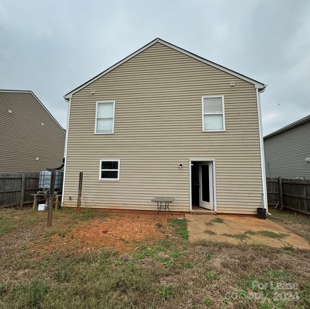 a view of house with backyard