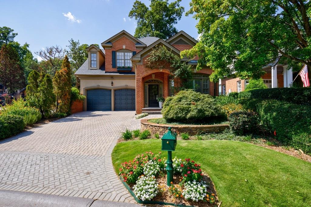 a front view of a house with a yard and potted plants