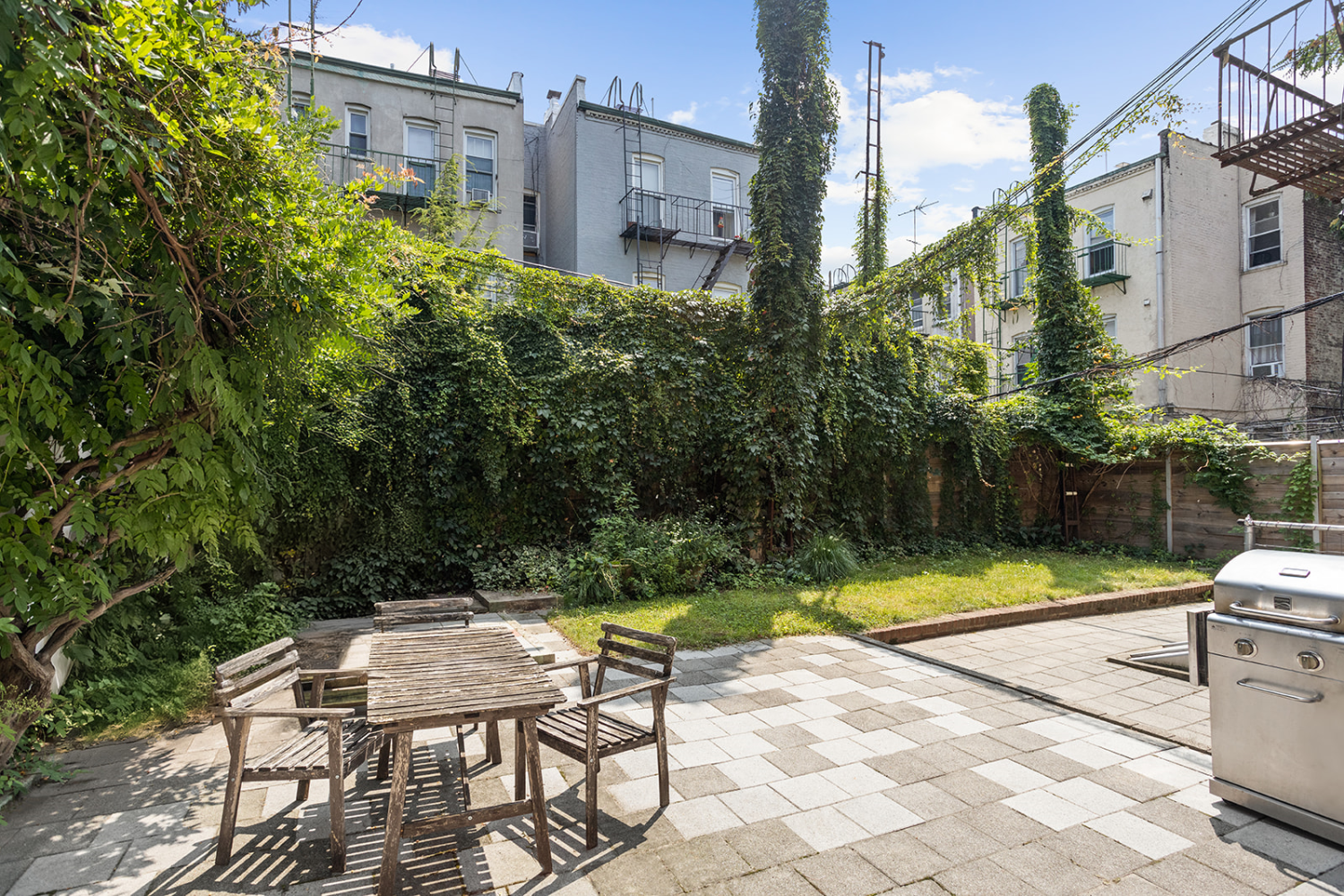 a view of backyard with swimming pool and seating