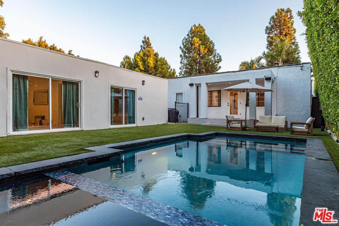 a view of a patio with swimming pool table and chairs