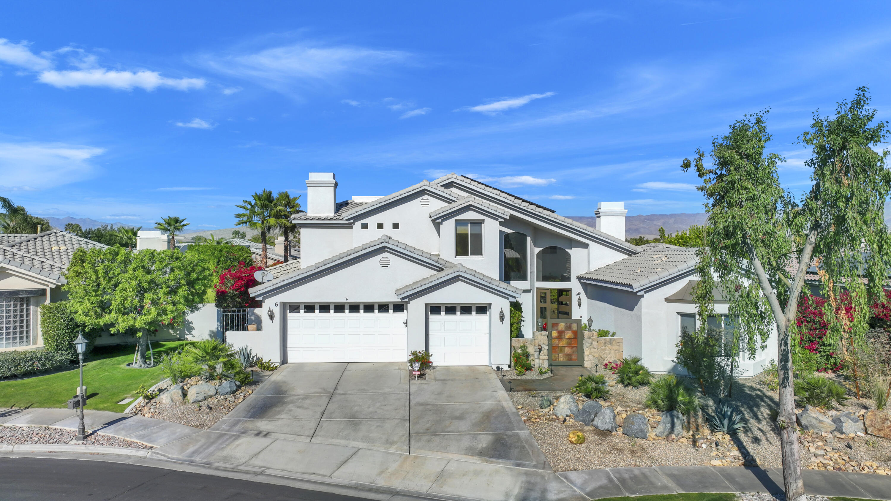 a view of a big house with a street