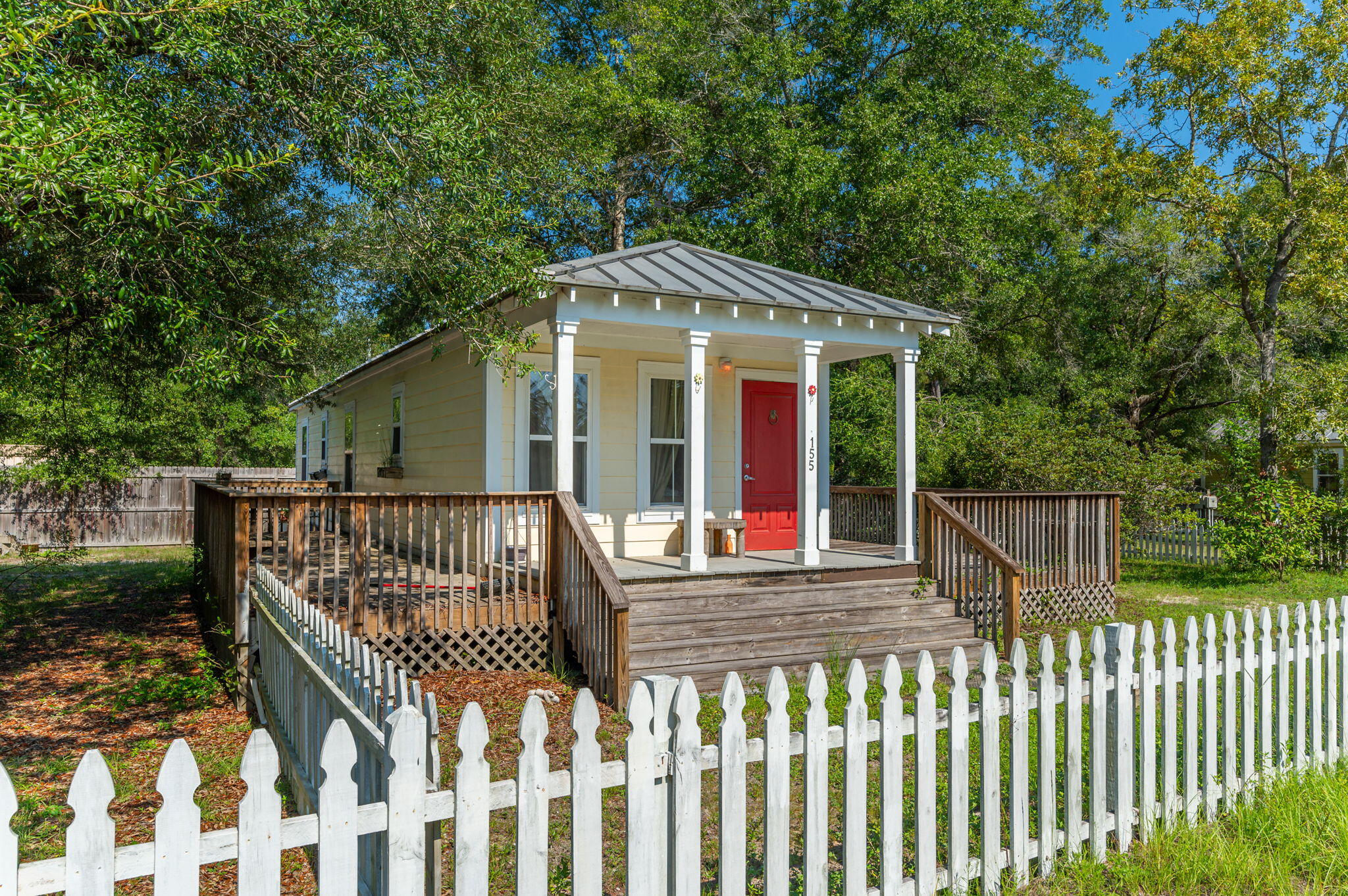 a view of a wooden house with a small yard