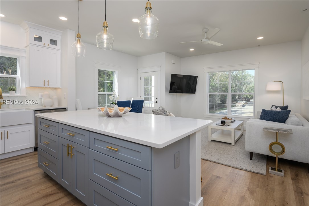 Kitchen with a healthy amount of sunlight, white c