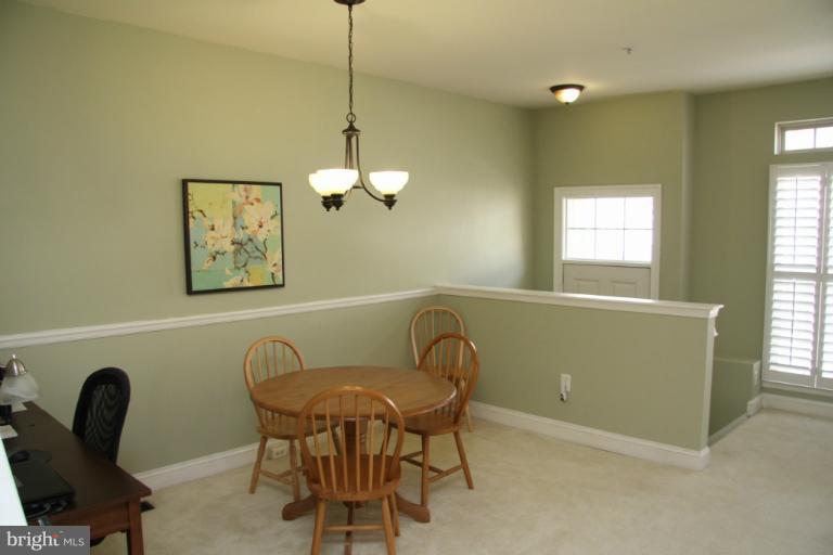 a view of a dining room with furniture and windows