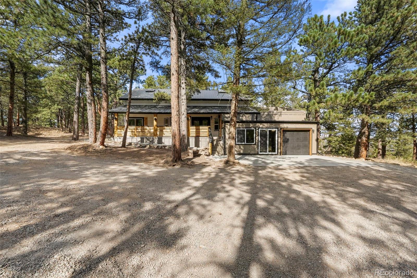 a front view of a house with a tree