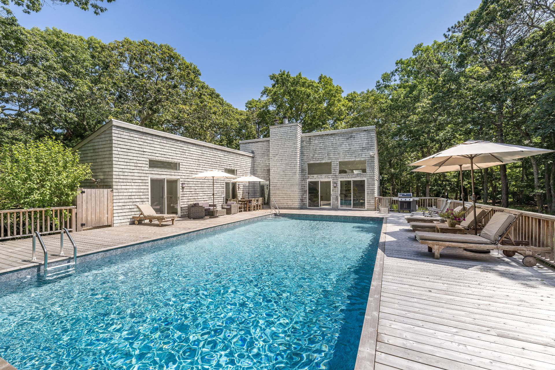 a view of a house with backyard sitting area and furniture