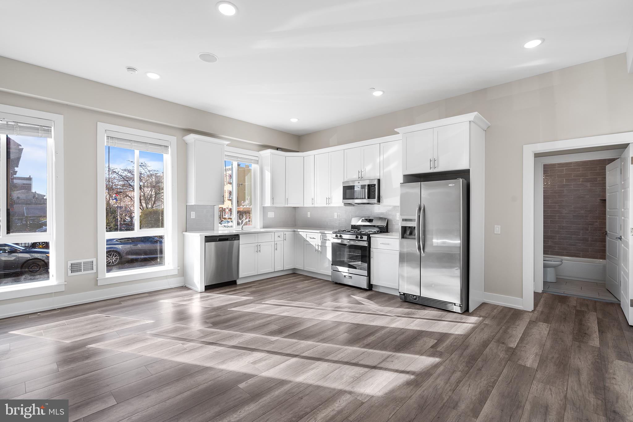 a kitchen with stainless steel appliances a refrigerator and a stove top oven