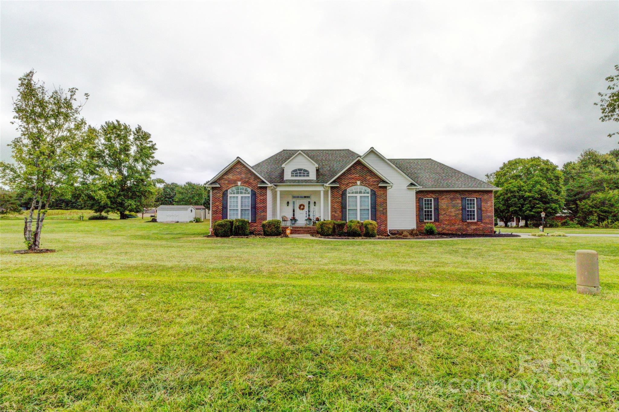 a front view of a house with a big yard