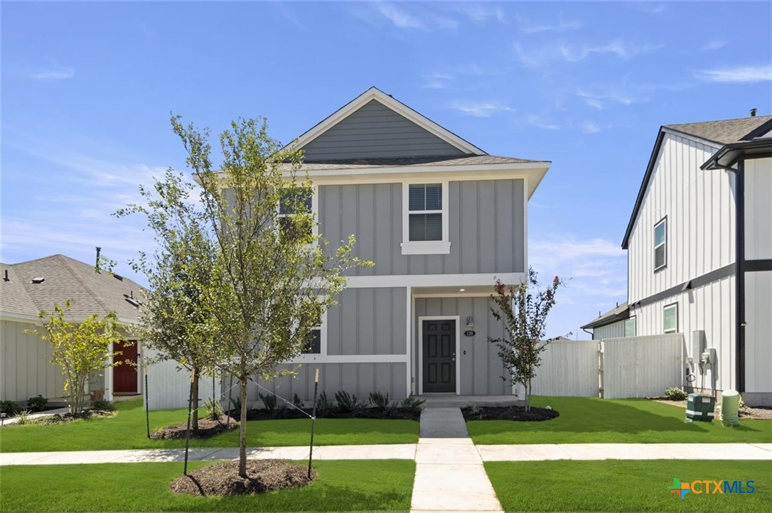 a front view of a house with a yard