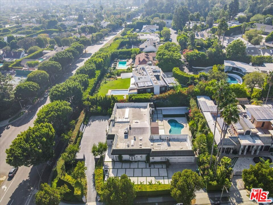 an aerial view of a houses with yard