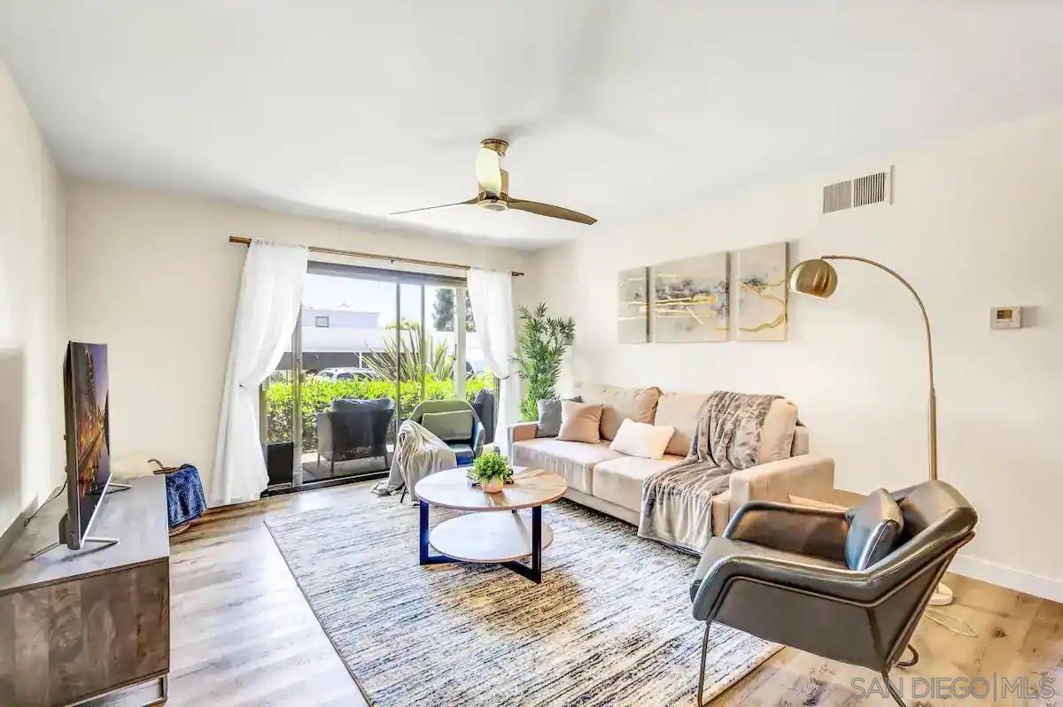 a living room with furniture and a floor to ceiling window