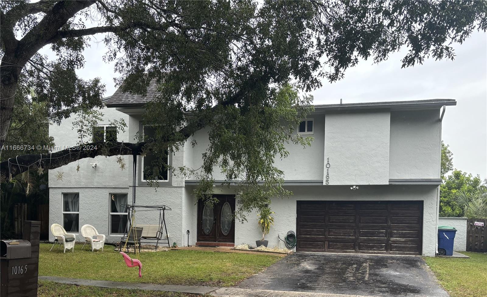 a front view of a house with garage