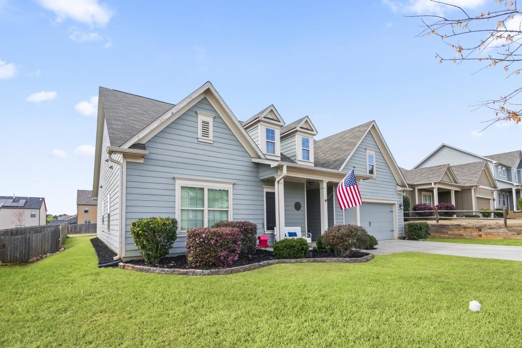 a front view of house with yard and green space