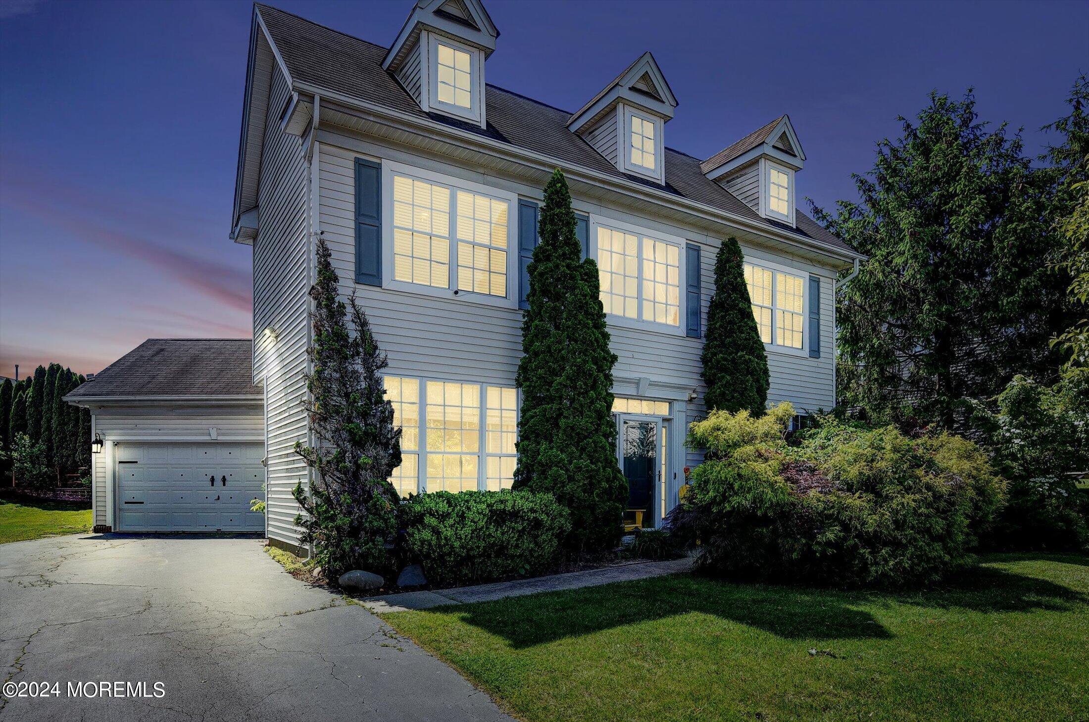 a front view of a house with a garden and plants