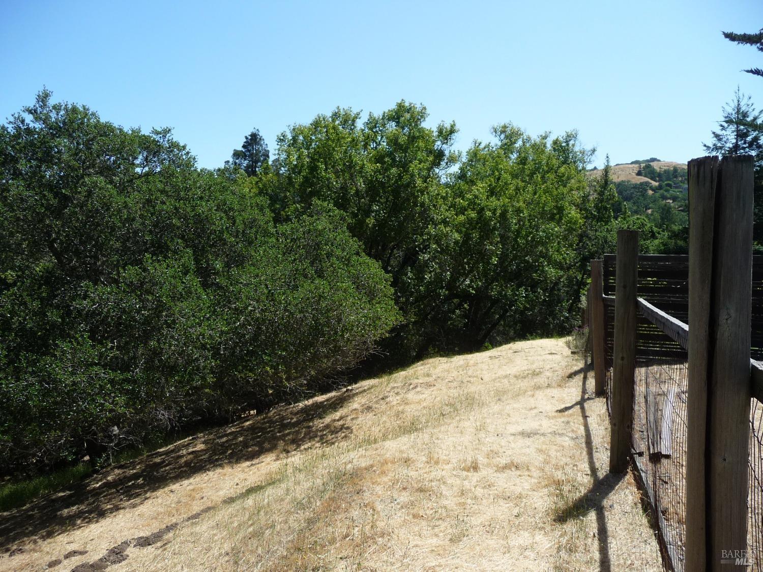 a view of wooden fence and trees