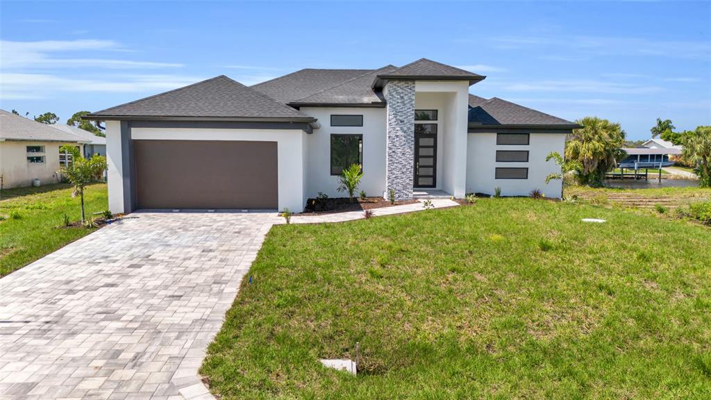 a front view of a house with a yard and garage