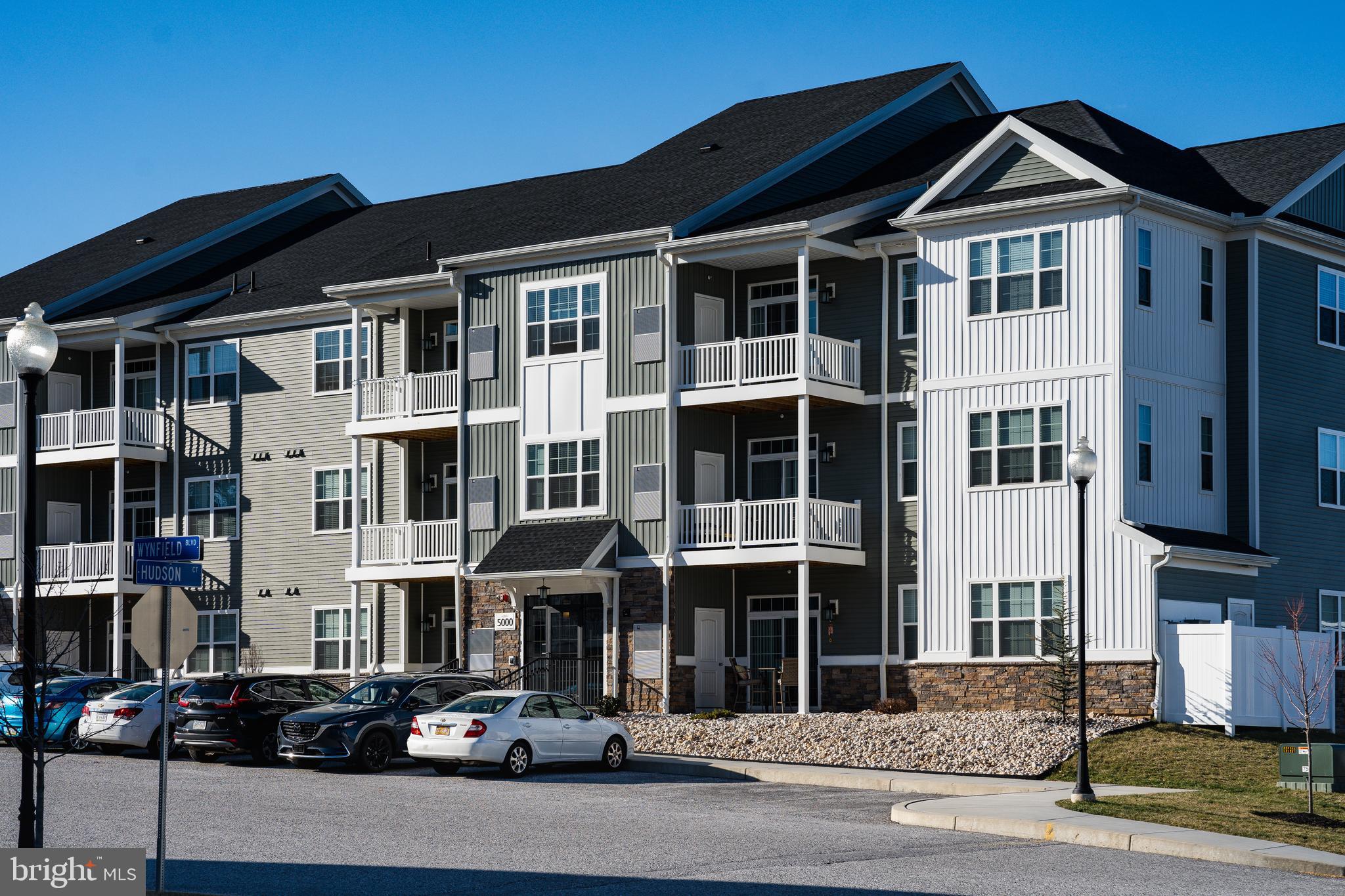 a front view of a residential apartment building with a street