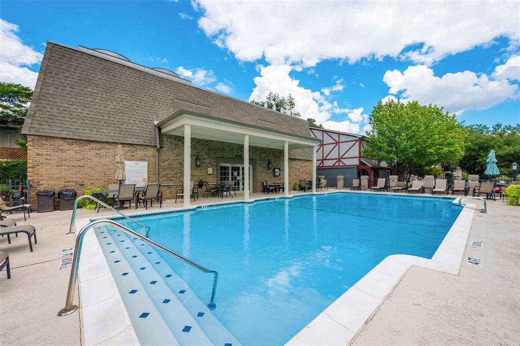 a view of a house with pool and chairs