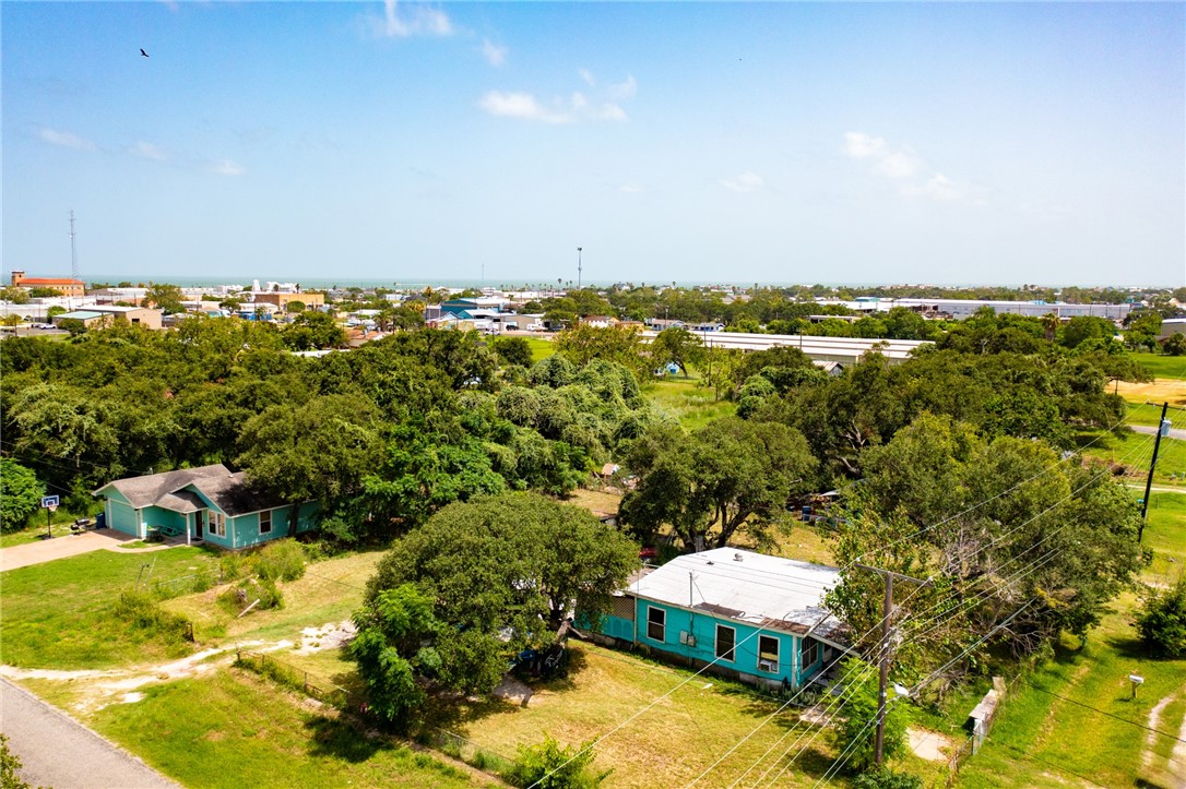 an aerial view of a house with a yard