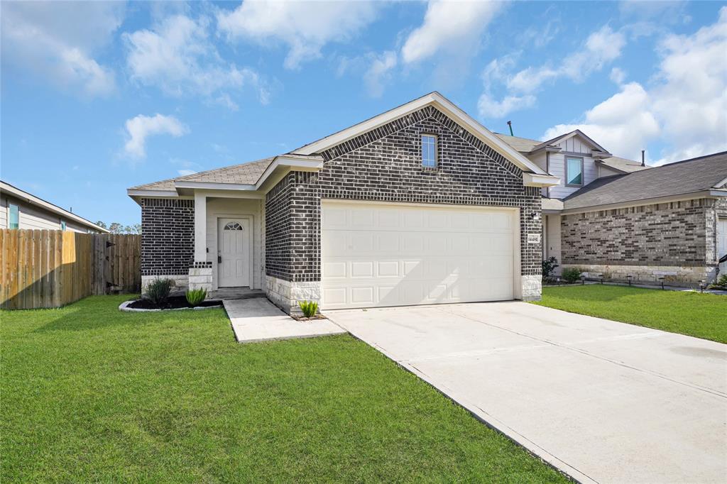 a front view of a house with a yard and garage