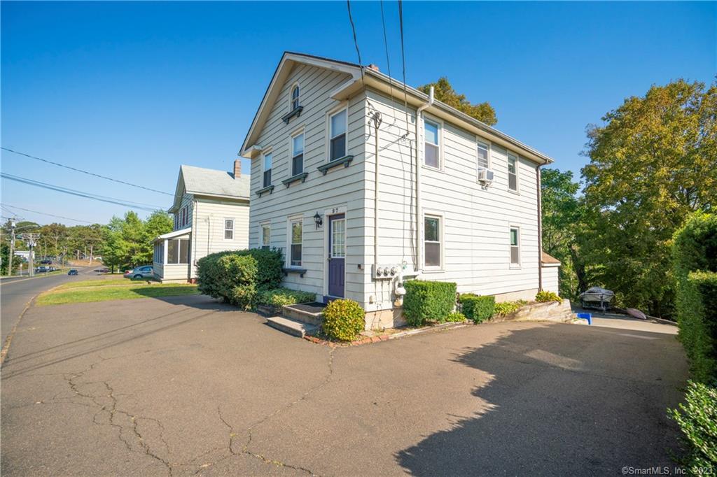 a view of a house with backyard and a garage