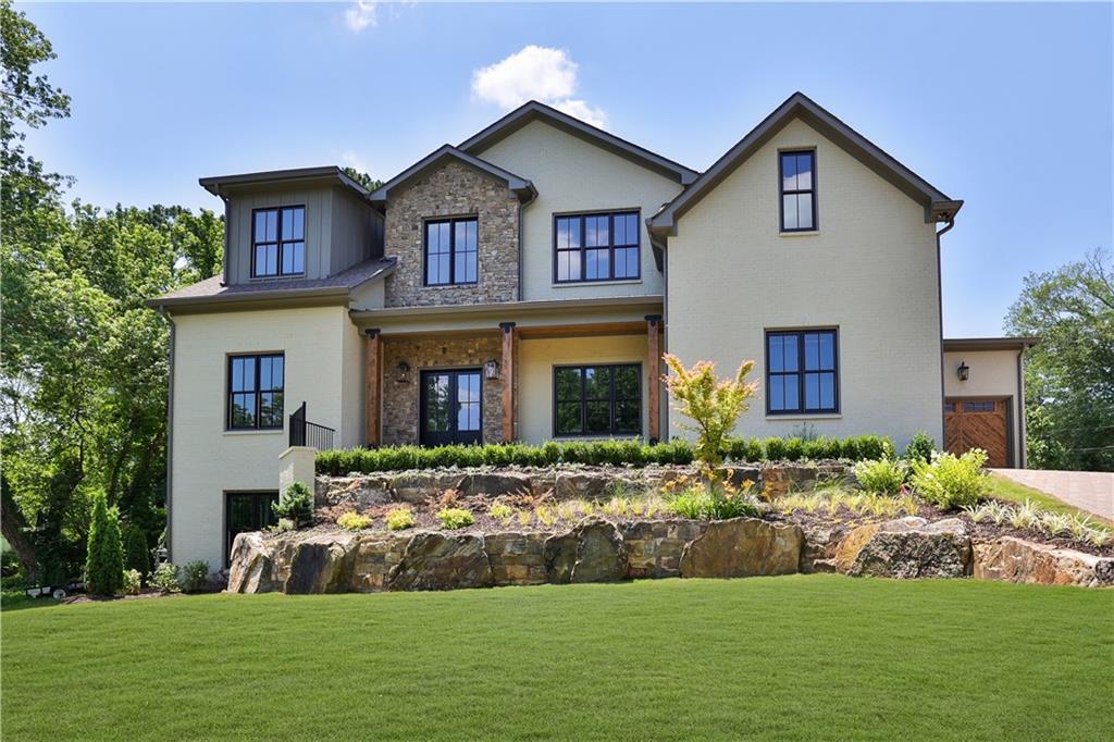 a front view of house with yard and green space