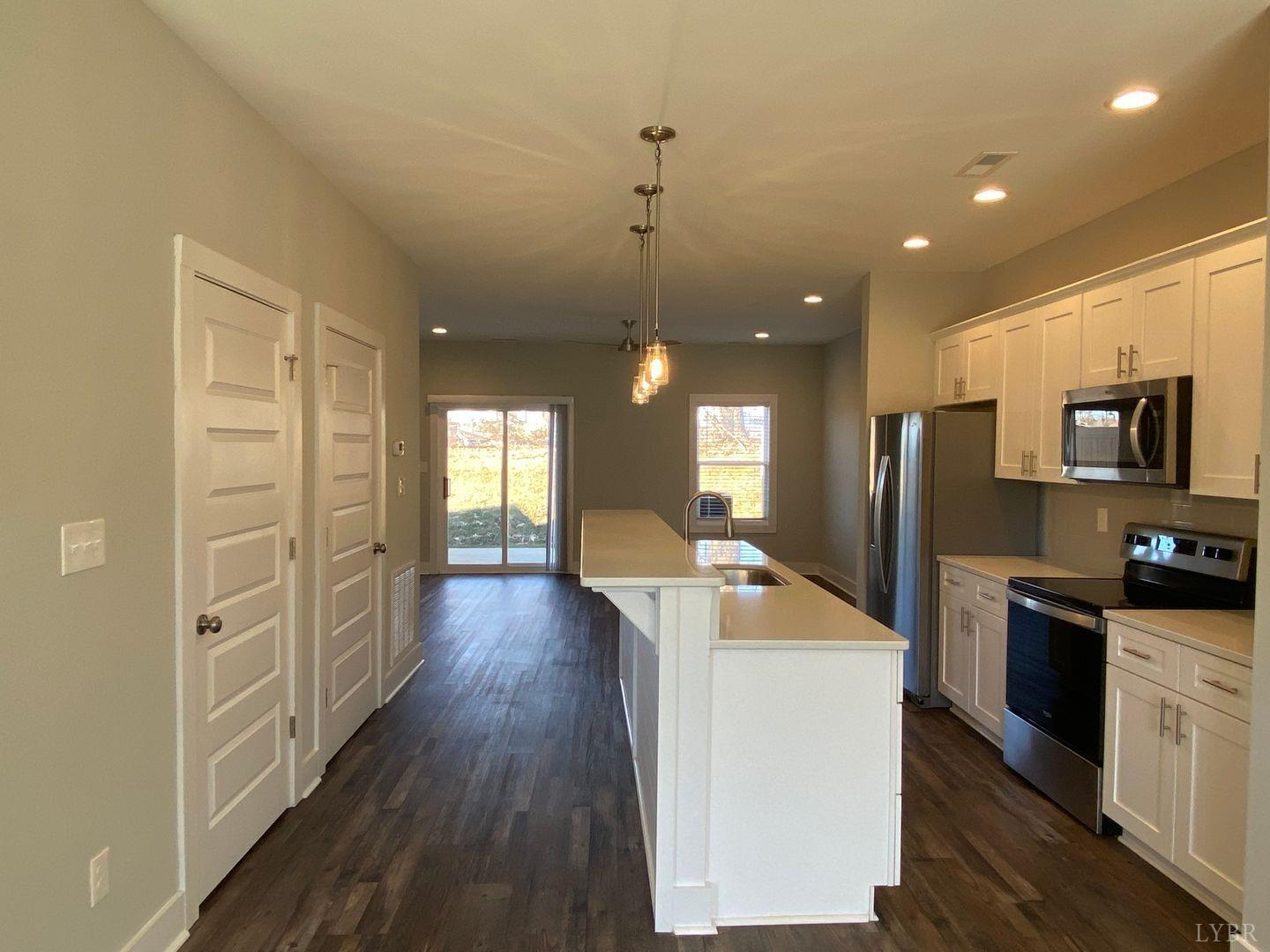 a kitchen with sink refrigerator and stove