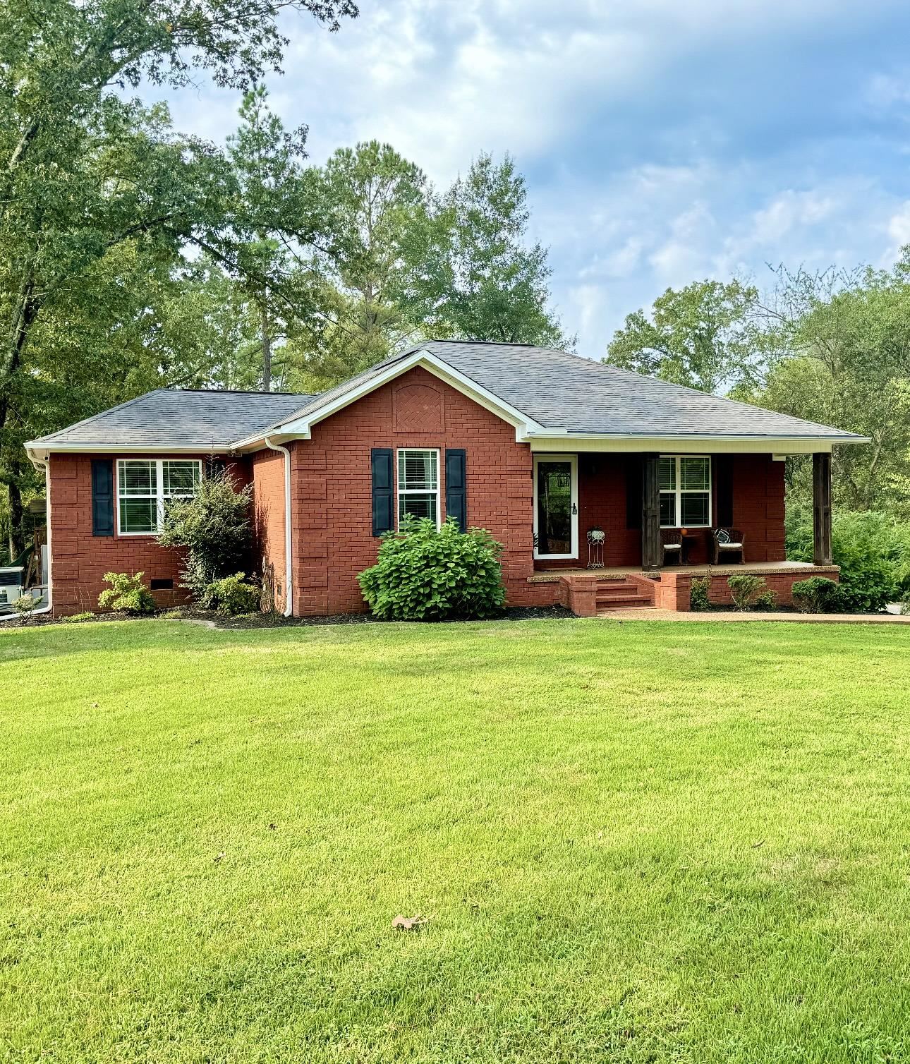 a front view of a house with a garden